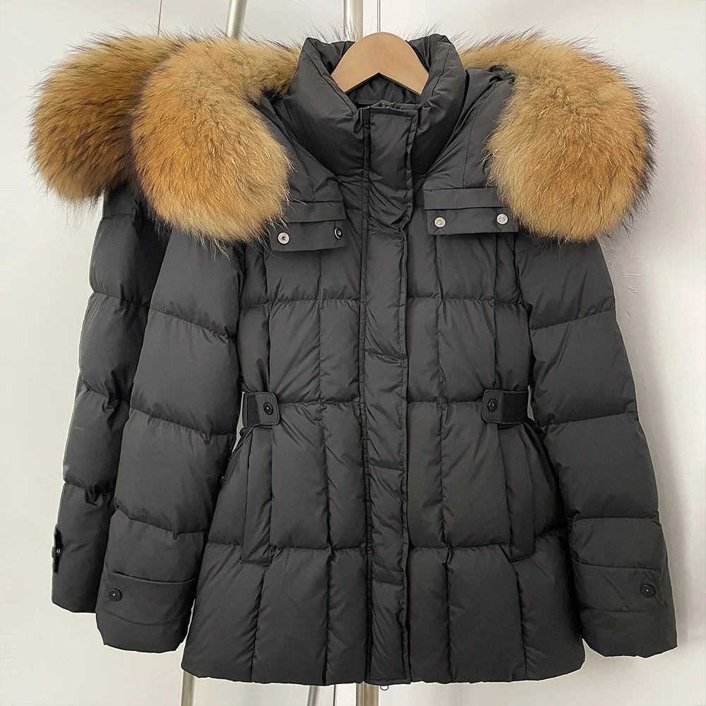 Dark gray puffer jacket with brown fur hood on a wooden hanger 