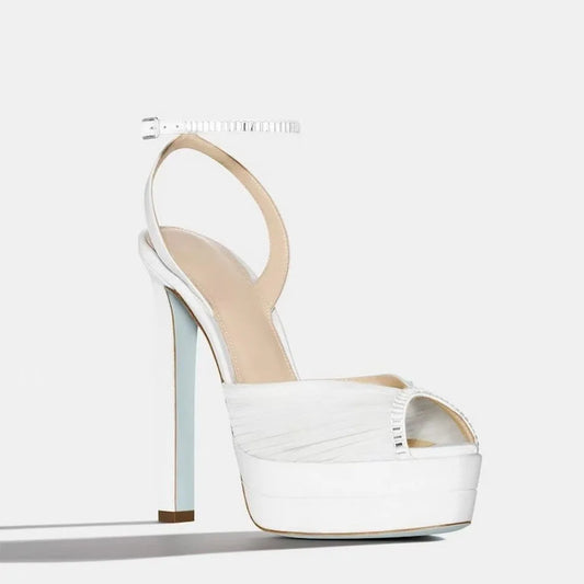 White platform rhinestone ankle strap heels, pleated satin upper, open toe.