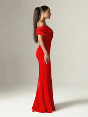 Woman wearing a red evening gown against a plain background