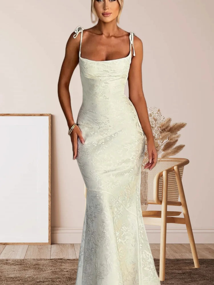 Woman wearing a light green lace dress in an indoor setting.