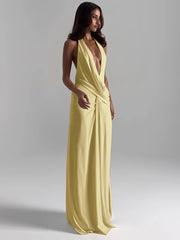 Woman wearing a yellow evening gown against a gray background