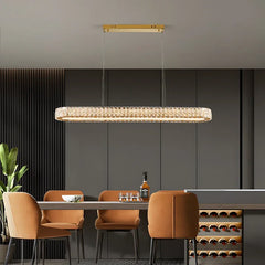 Modern dining area with a rectangular chandelier, table, chairs, and wine rack.