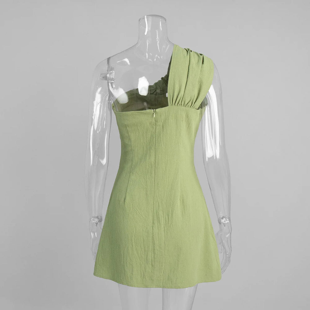 Green dress on a mannequin against a gray background