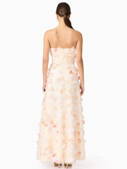 Woman wearing a strapless gown with floral details on a white background