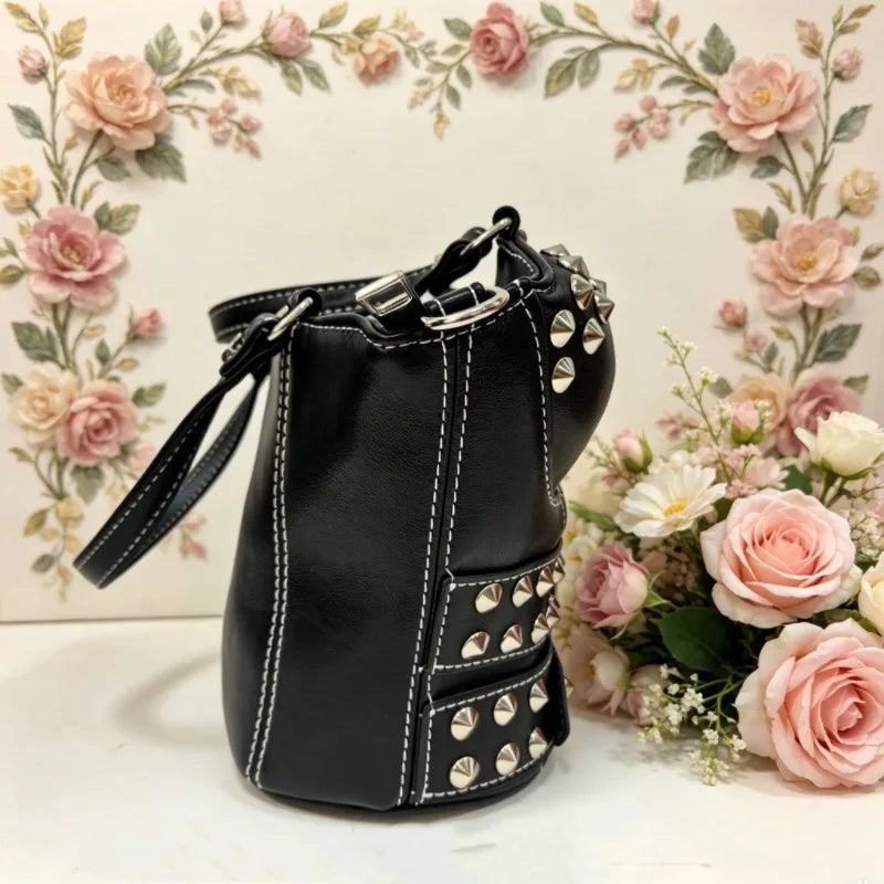 Side view of black studded buckled corset bag