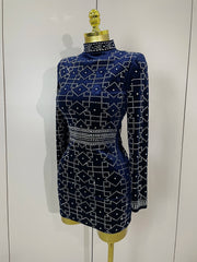 Navy blue dress with white geometric pattern on a mannequin against a white background