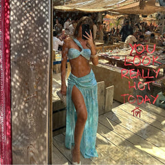 Woman wearing printed swimwear set in a beachside setting