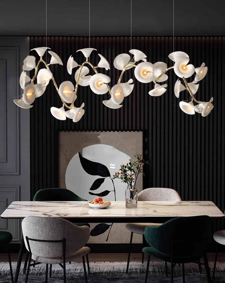 Modern dining room with a decorative chandelier, table, and chairs.