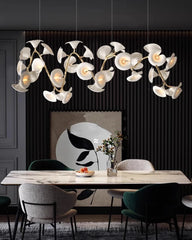 Modern dining room with a decorative chandelier, table, and chairs.
