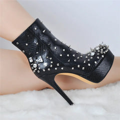 Black studded and rhinestone platform ankle boot on a leg