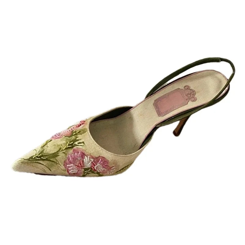 Floral high-heeled shoe on a white background