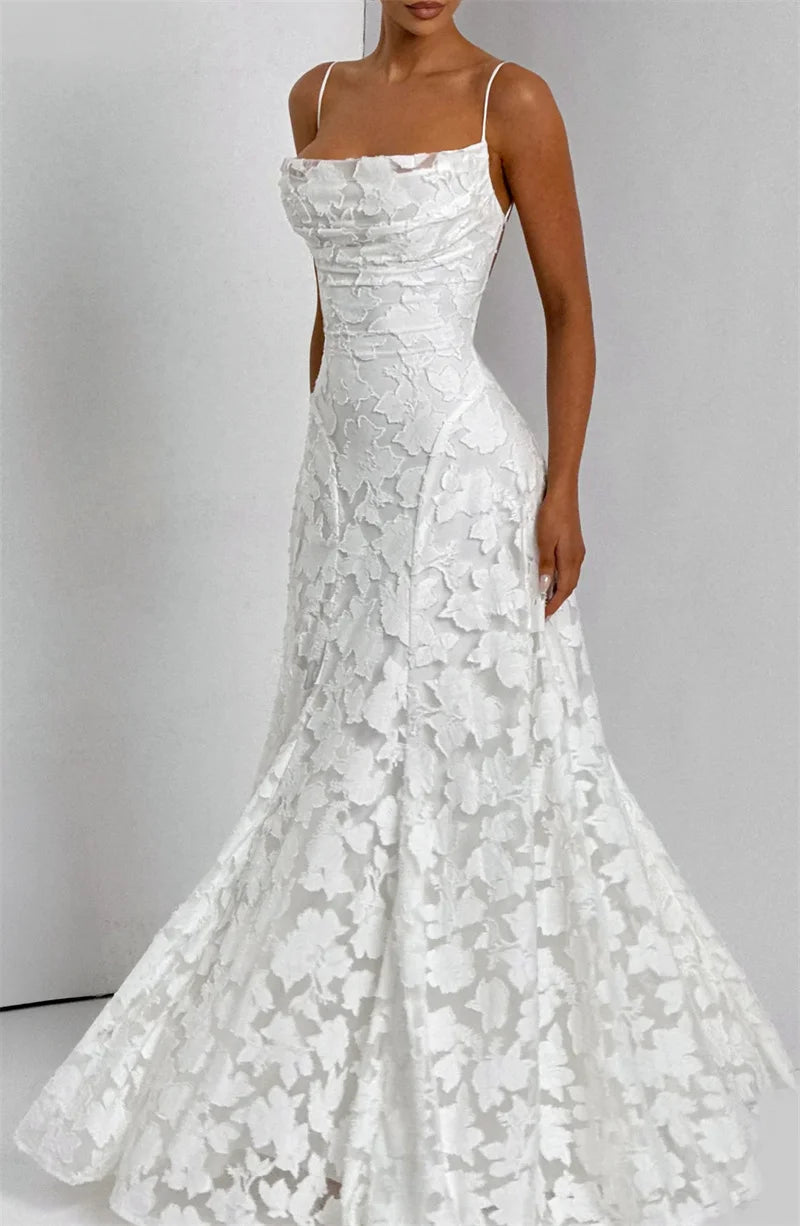 White lace wedding dress on a plain background