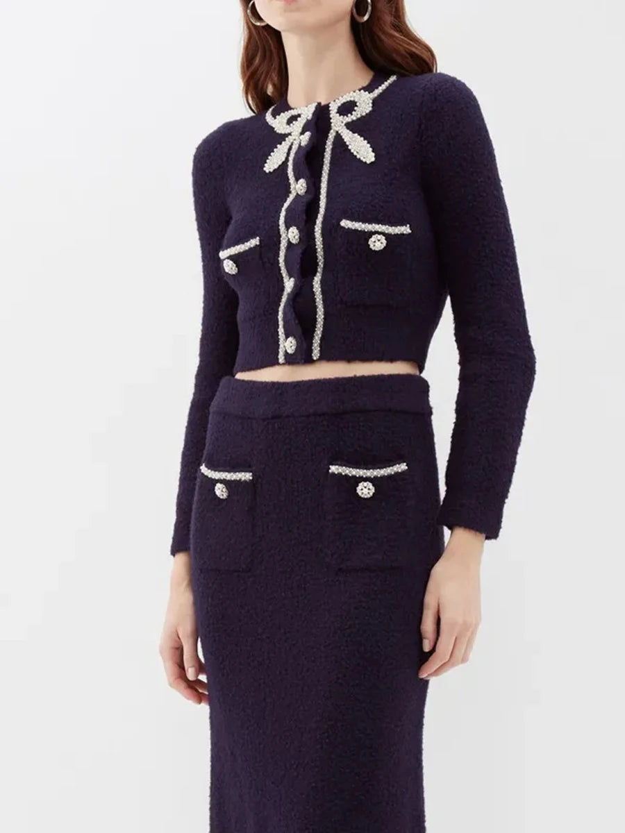 Navy blue outfit with white buttons on a white background