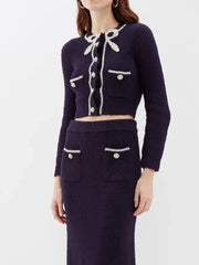 Navy blue outfit with white buttons on a white background