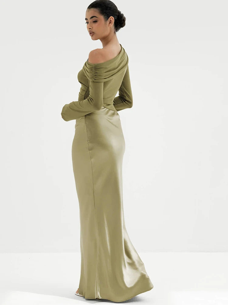 Woman wearing a green off-shoulder gown on a white background
