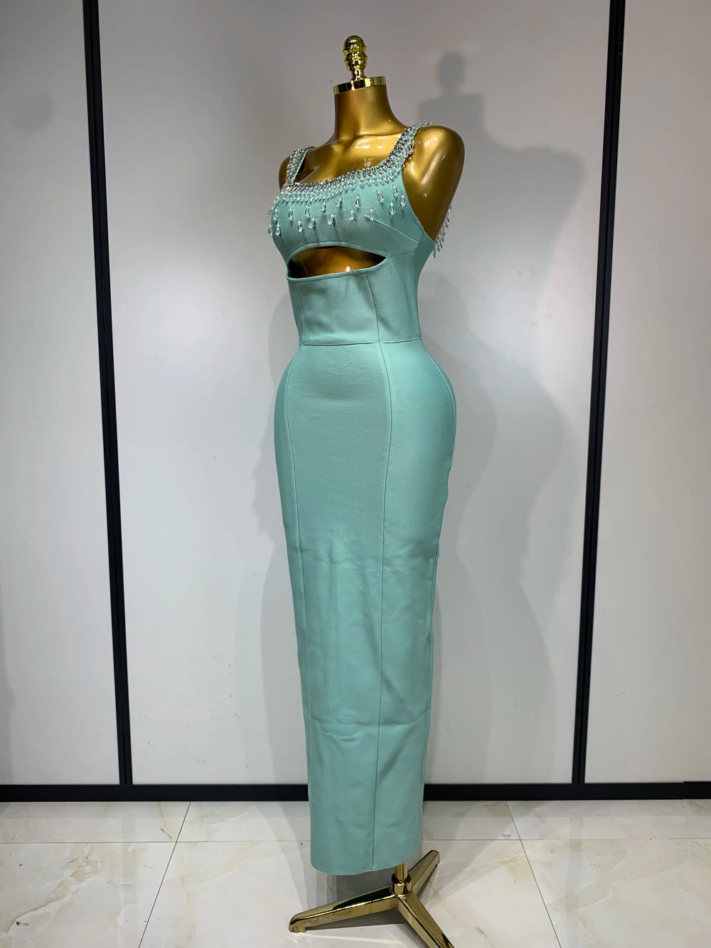 Side view of a form-fitting column dress with beaded embellishments