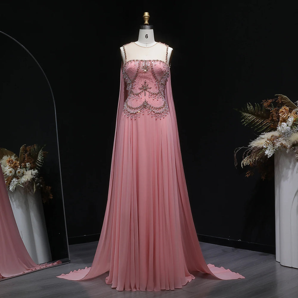 Pink evening gown on a mannequin against a black background with floral decorations.