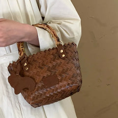 Woman carrying a woven crossbody beach bag  , showcasing its stylish and practical design. Golden Atelier 3