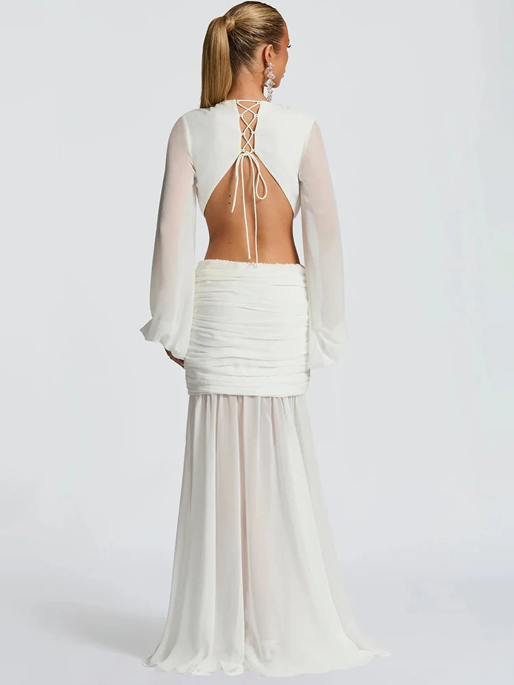 White dress with sheer sleeves and open back on a white background