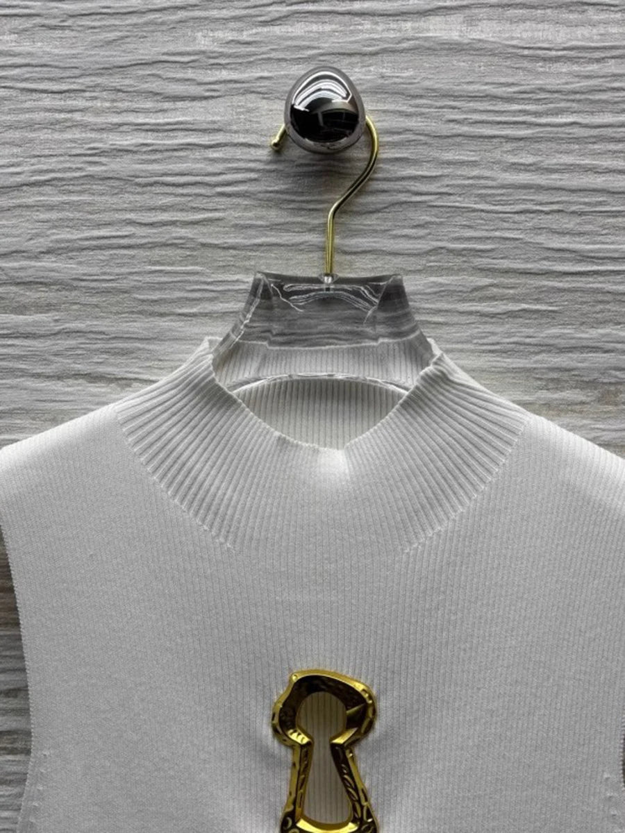White sweater on a hanger against a textured gray background