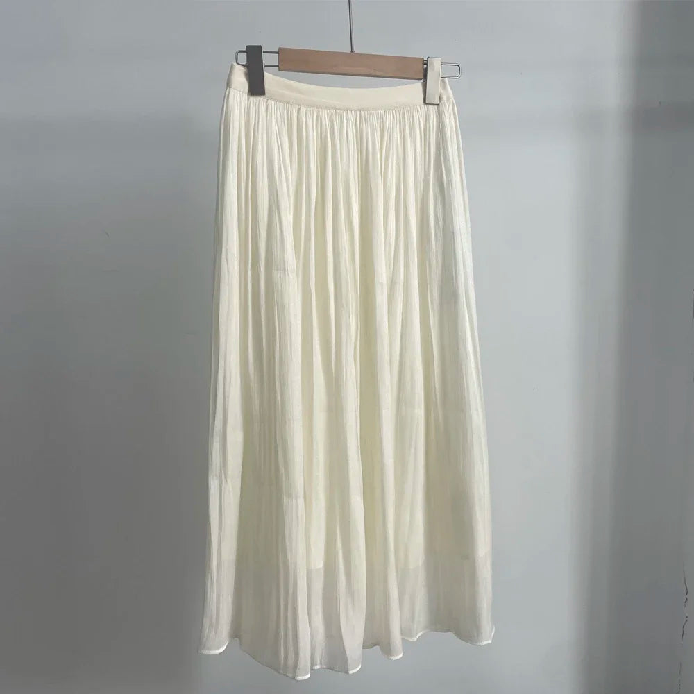 White skirt on a hanger against a gray background