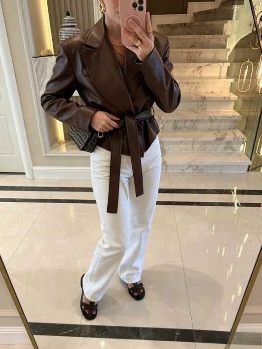 Faux leather belted lapel jacket worn with white jeans