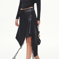 Model wearing an asymmetrical faux leather midi skirt with lace detail