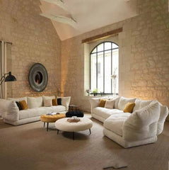 Soft Italian-style cloud couch with mustard pillows and boucle ottomans