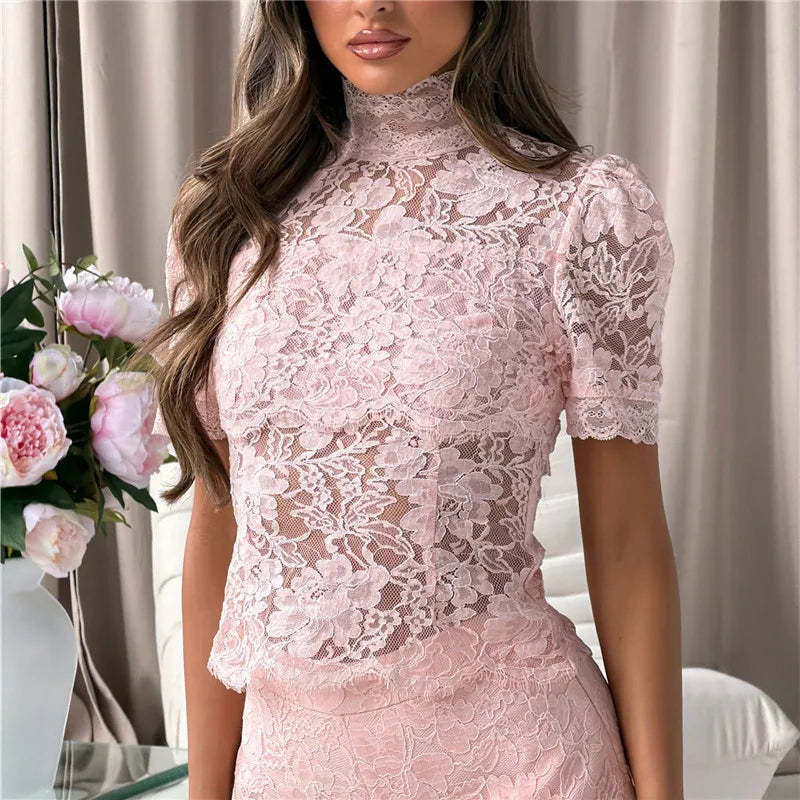Model wearing a pink sheer floral lace mock neck puff sleeve top