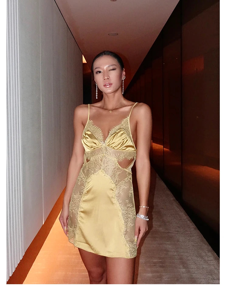 Woman wearing a yellow lace dress in an indoor setting