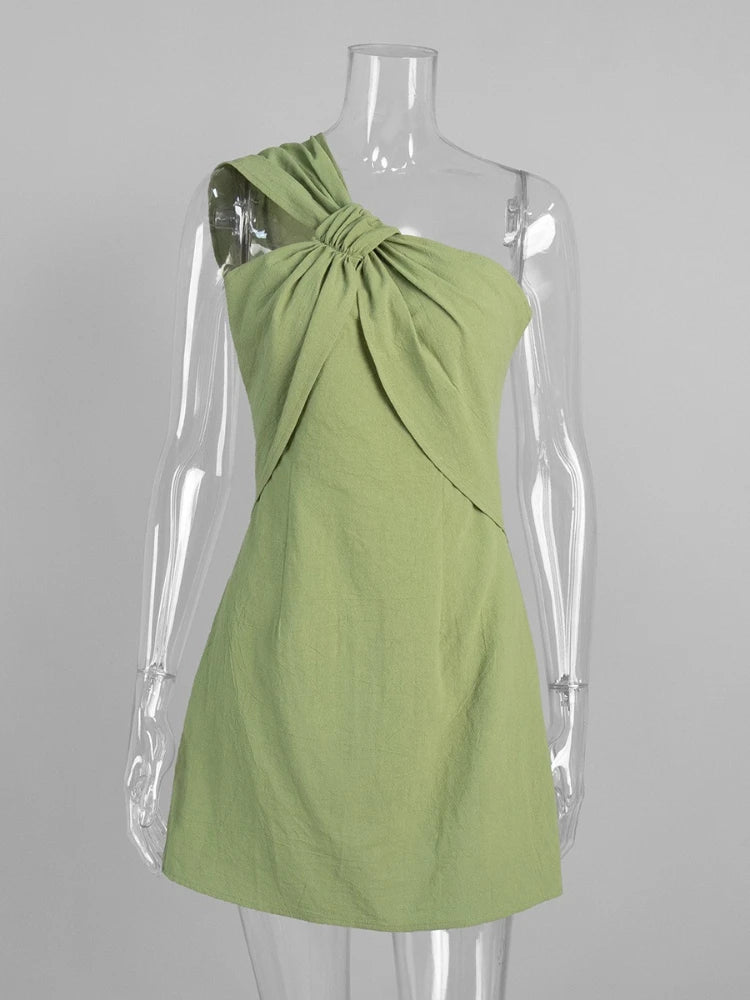 Green dress on a mannequin against a gray background