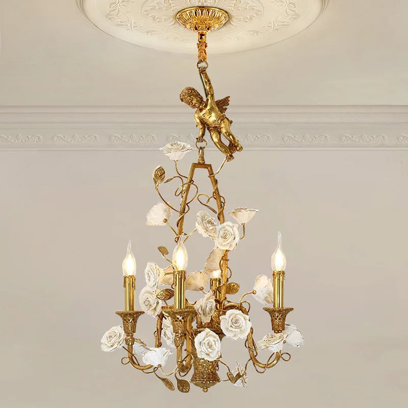 Decorative chandelier with gold accents and floral elements on a neutral wall background