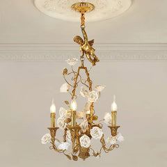 Decorative chandelier with gold accents and floral elements on a neutral wall background