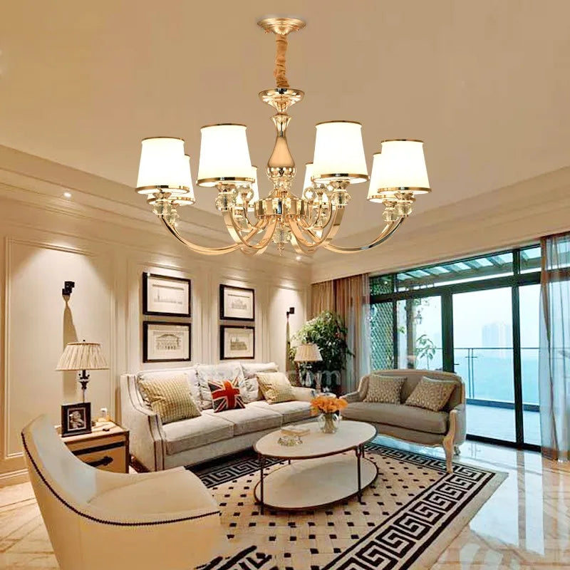 Elegant silver crystal chandelier with frosted glass shades illuminating a modern luxury living room