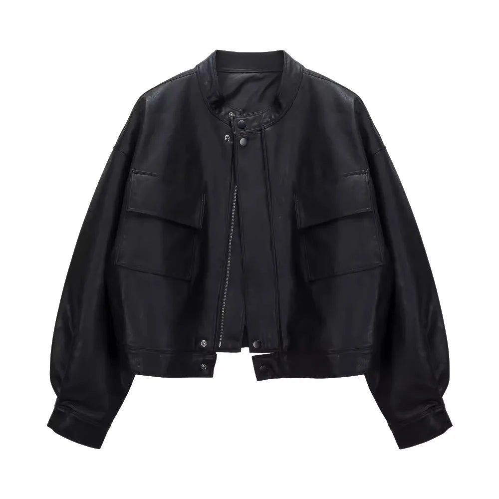 Black cropped faux leather jacket with round neck and dual front pockets.