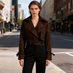 Woman in a brown coat standing on a city street