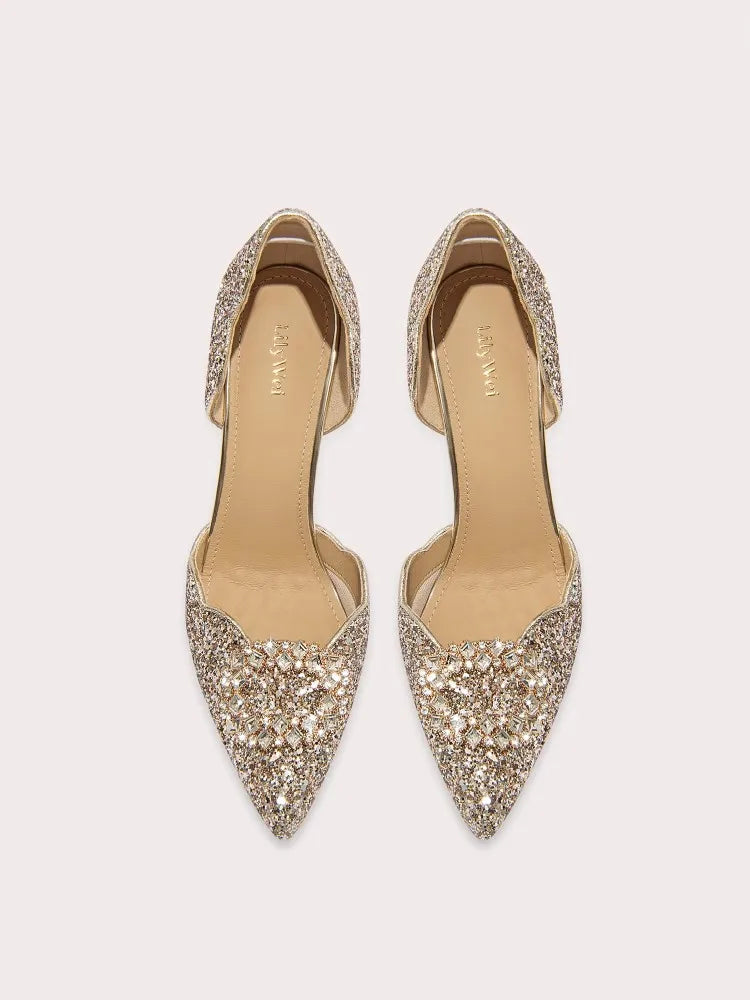 Pair of embellished high-heeled shoes on a light beige background