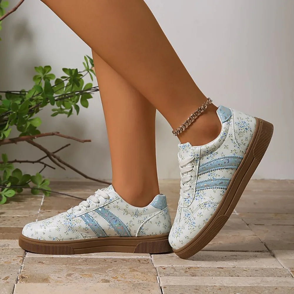 Floral print lace-up sneakers with a round toe and rubber sole.