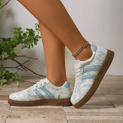 Floral print lace-up sneakers with a round toe and rubber sole.
