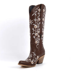 Side view of brown floral embroidered pointed toe knee high cowboy boots