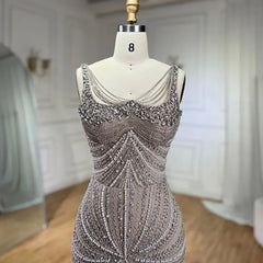   Mannequin displaying the pearl-beaded mermaid evening gown, showcasing its flattering silhouette and flowing train. Golden Atelier 4