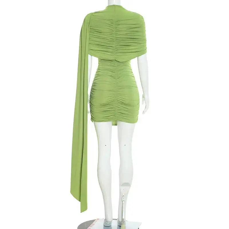 Green dress on a mannequin against a white background