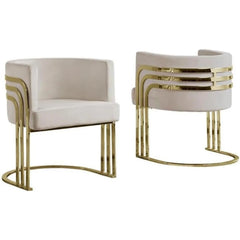 Two modern chairs with beige cushioned seats and gold metal frames on a white background