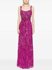 Woman wearing a pink sequin dress on a white background