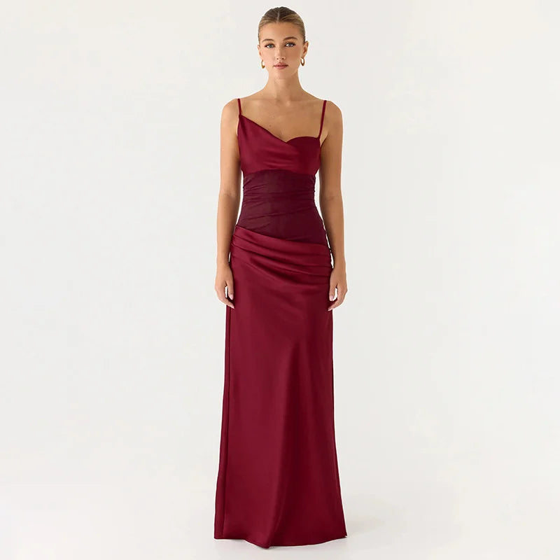 Woman wearing a burgundy one-shoulder gown on a white background
