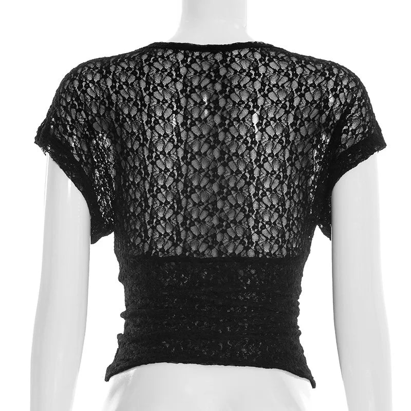 Black lace top on a mannequin against a white background