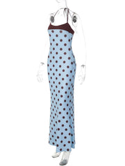 Blue dress with brown polka dots on a mannequin against a white background