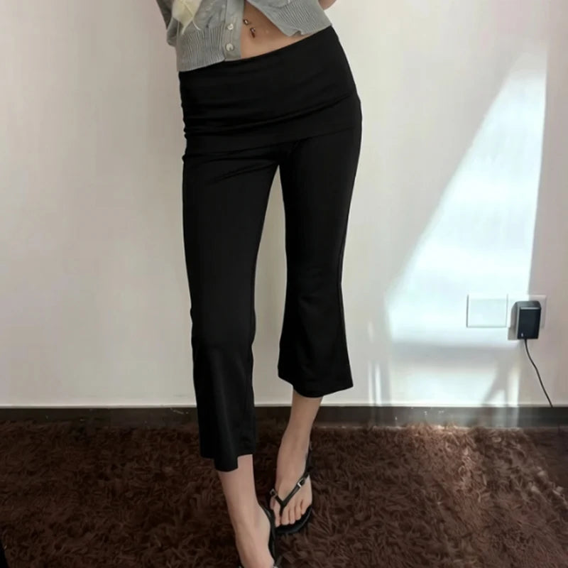 Black cropped flare pants with a fold-over waist.