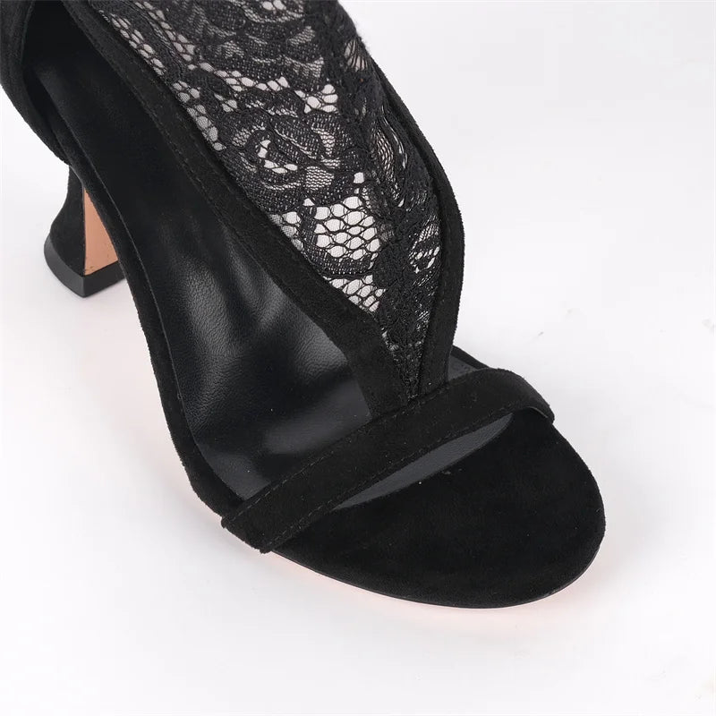 Close-up of the toe and strap detail on black lace over the knee boots.