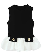Black top with white hem and gold floral accents on a white background